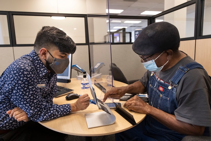 Associate banker Ramon Ramos (left) assists local resident Jacob Polk at the new Chase...