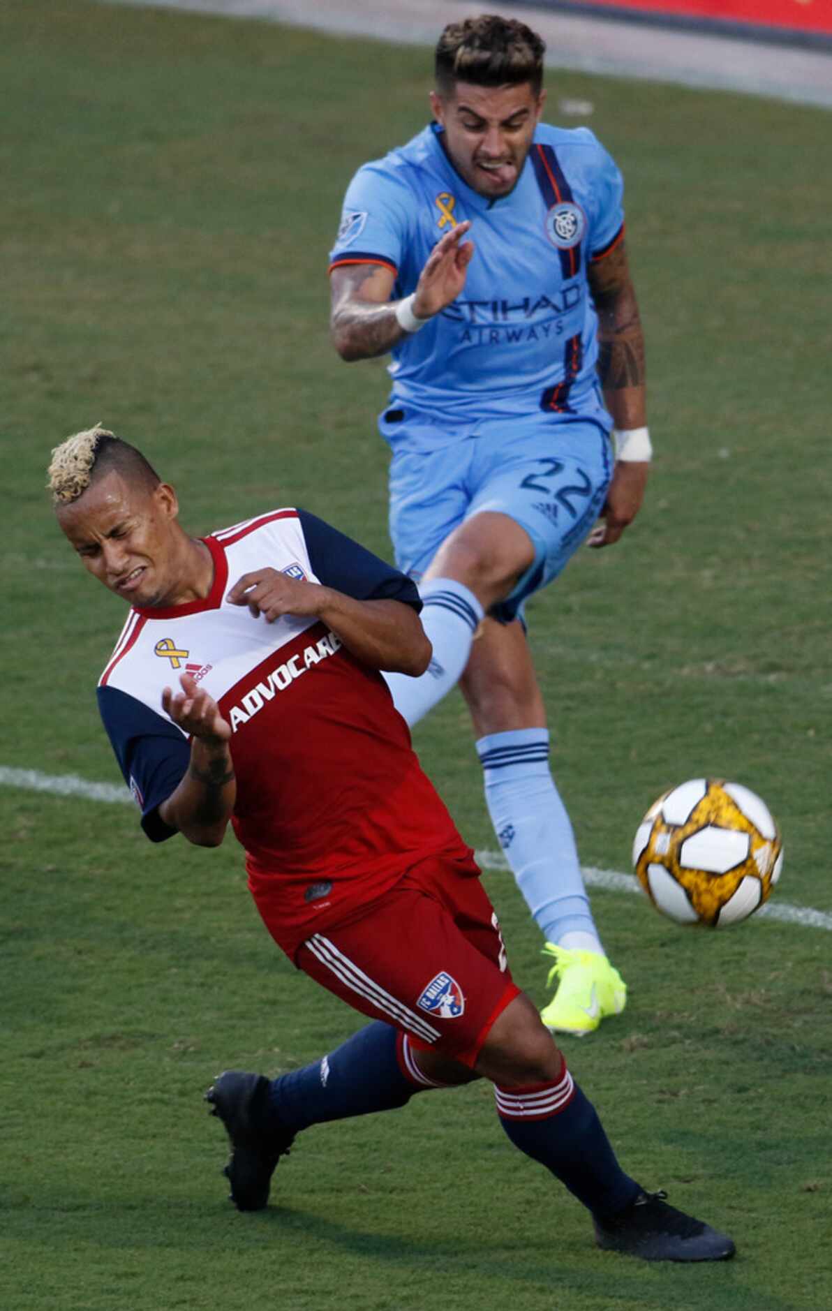 FC Dallas midfielder Michael Barrios (21) reacts just in time to save face as New York City...