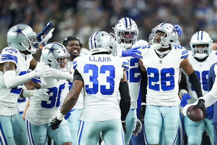 Dallas Cowboys cornerback DaRon Bland (26) celebrates with teammates after intercepting a...