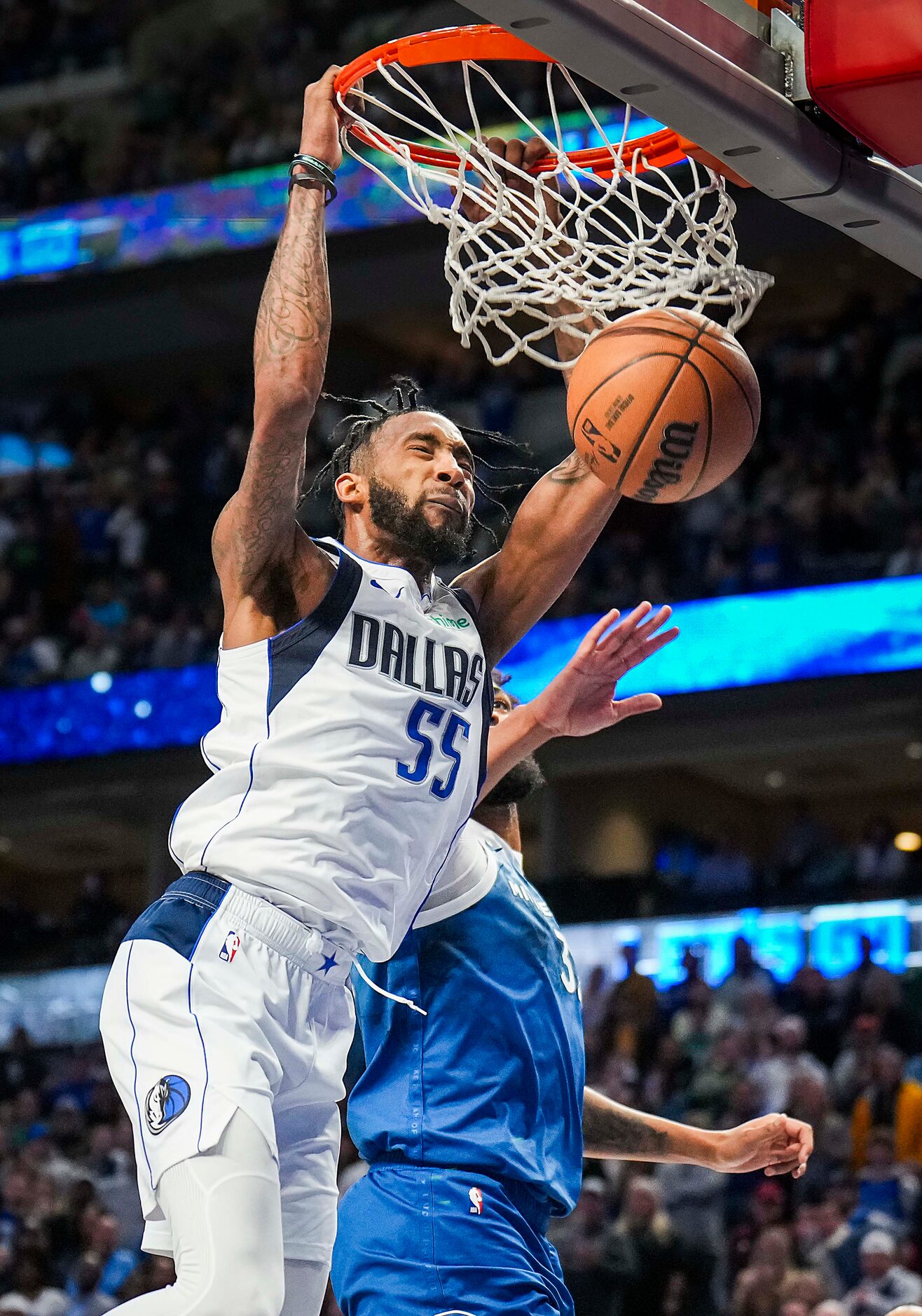 Dallas Mavericks forward Derrick Jones Jr. (55) dunks the ball over Minnesota Timberwolves...