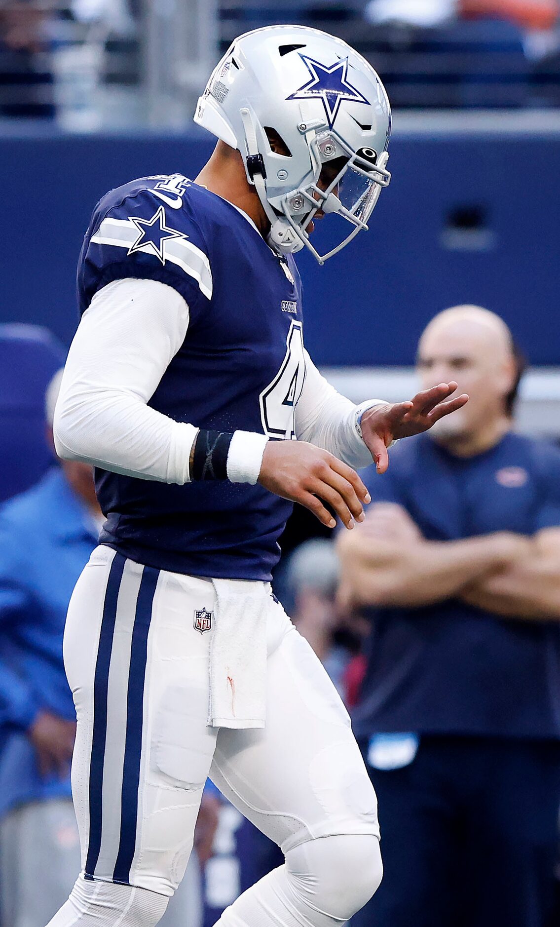 Dallas Cowboys quarterback Dak Prescott (4) looks at his left hand which was stepped on by...