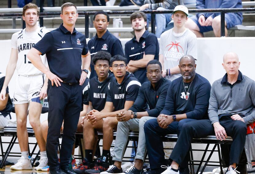 Arlington Martin coaching staff and teammates watch players in the game against Arlington...