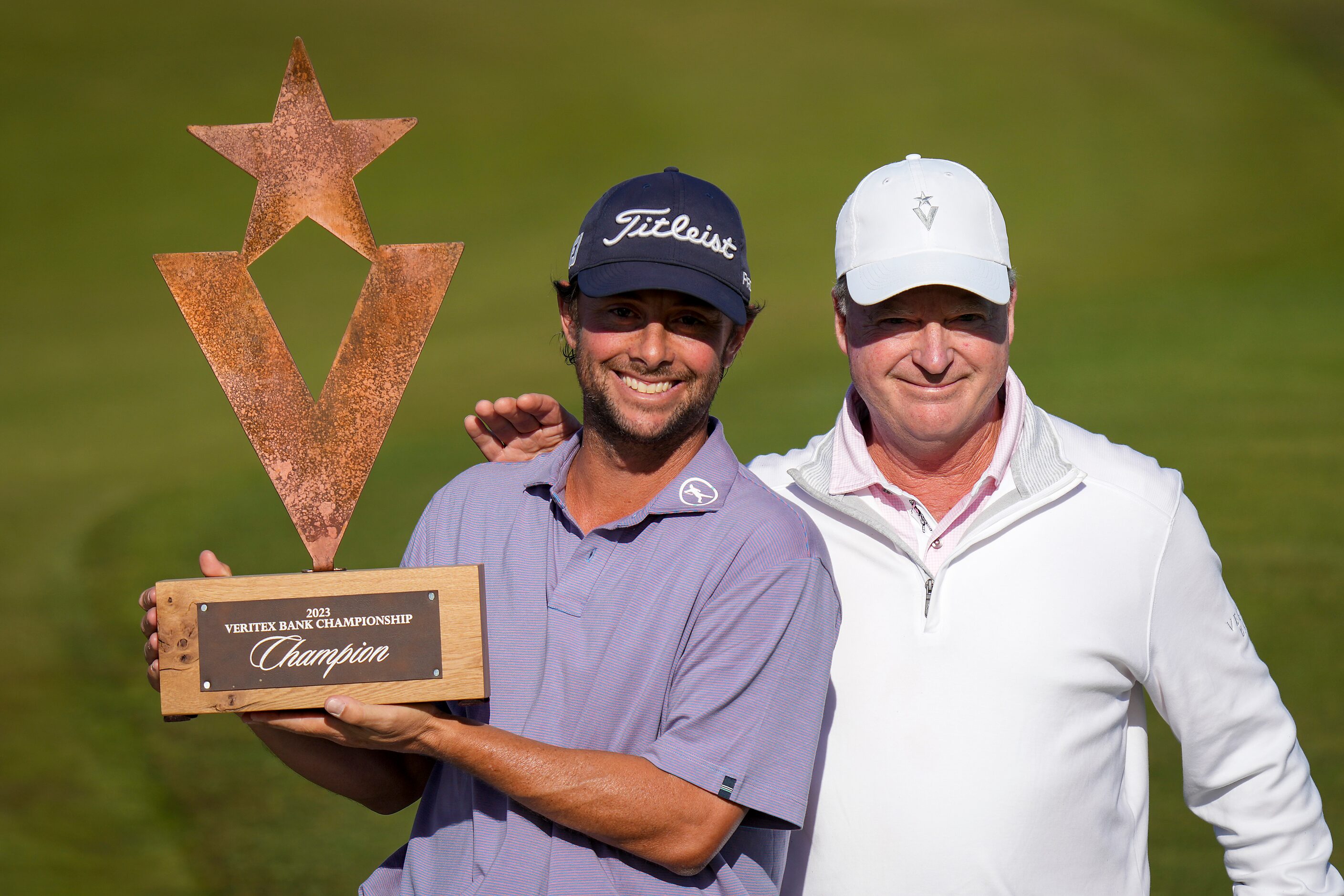 Spencer Levin (left) holds the trophy with Veritex CEO Malcolm Holland after winning the...