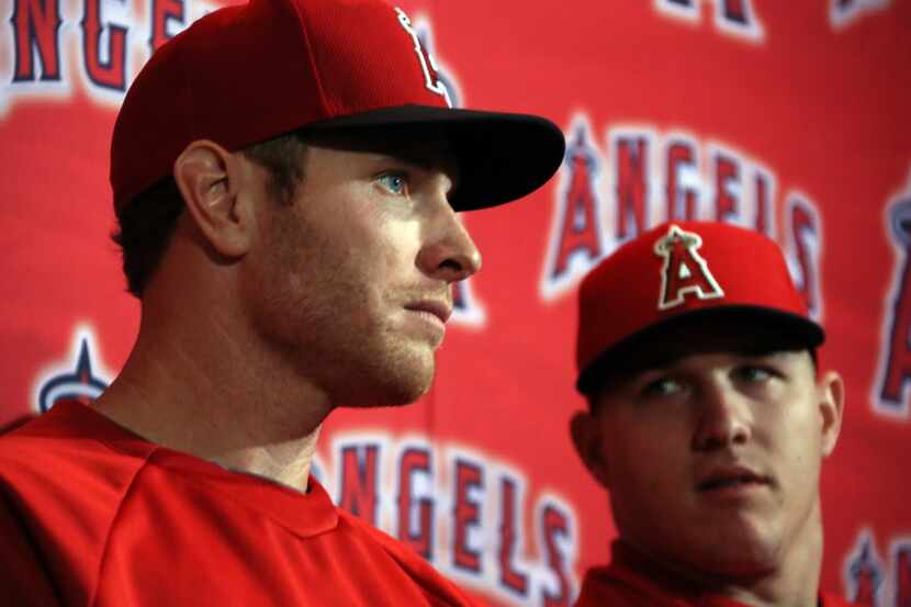 Angels' outfielder Josh Hamilton is pictured with teammate Mike Trout during a press...