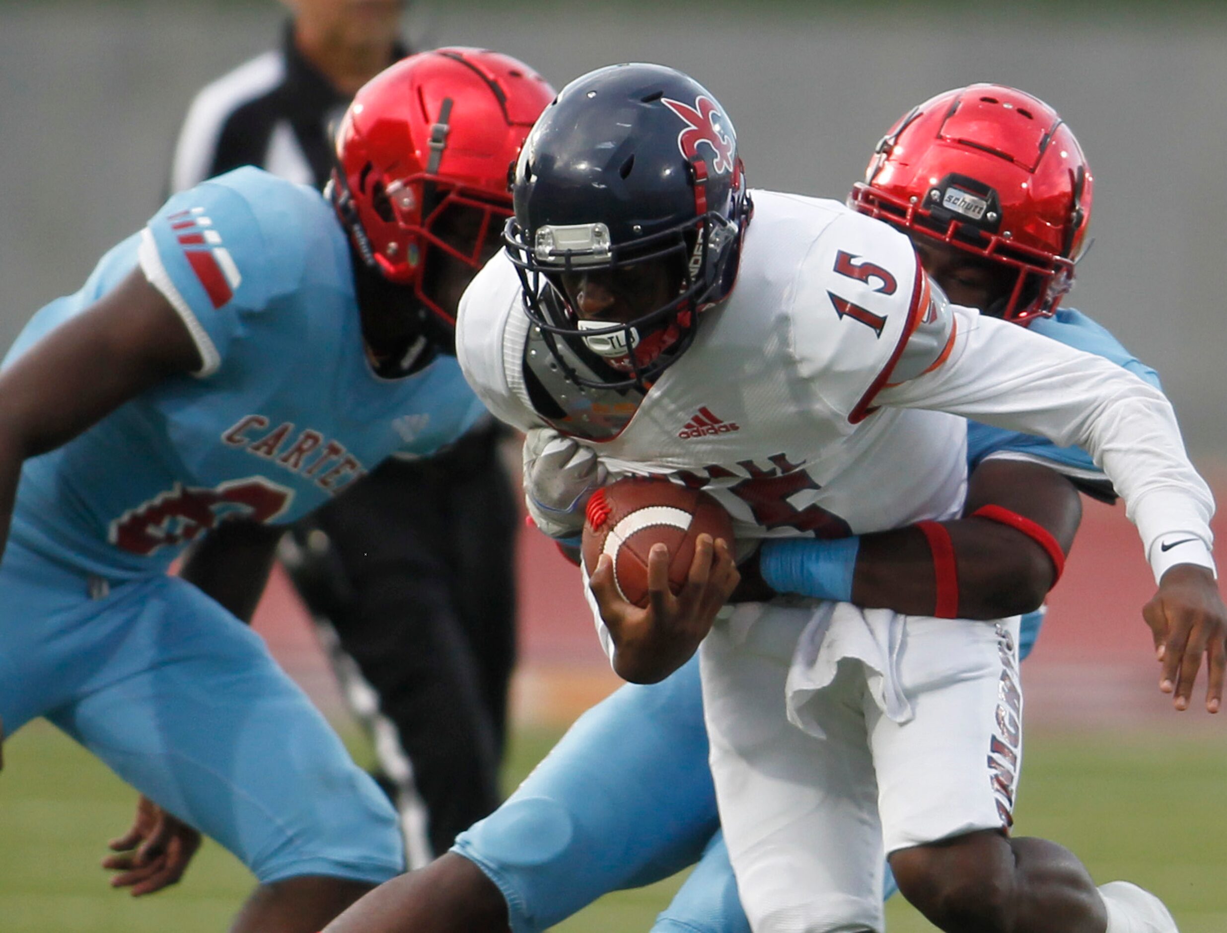 Dallas Kimball quarterback Marc Anderson (15) rushes into the secondary before being stopped...