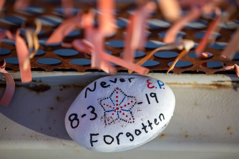 A decorated rock remembering the victims of the August 2019 mass shooting rests at a...