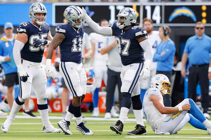 Dallas Cowboys linebacker Micah Parsons (11) is congratulated by defensive tackle Osa...