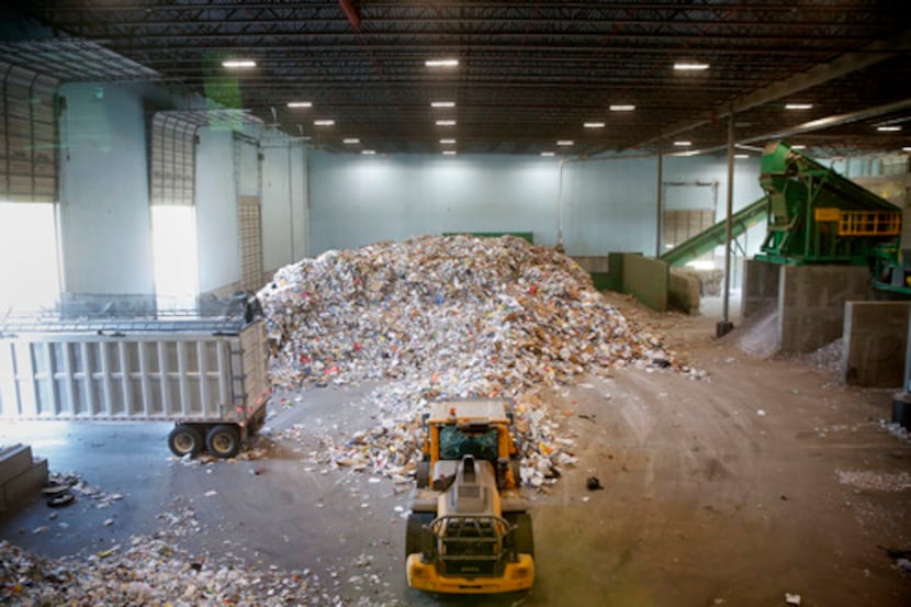 Recyclable material is piled on the tipping floor ready to be sorted at the City of Dallas...