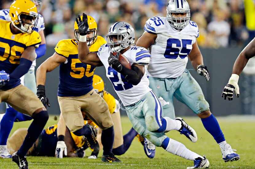 Dallas Cowboys running back Ezekiel Elliott finds a hole during Dallas' 30-16 win over the...