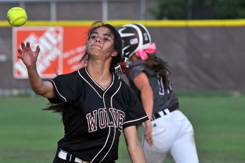 Timberview junior Nala Stokes (6) tosses the ball to first base as Lewisville sophomore...