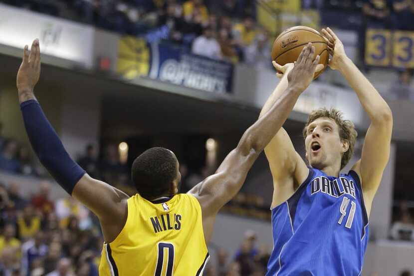 Dallas Mavericks' Dirk Nowitzki (41) puts up a shot against Indiana Pacers' C.J. Miles (0)...