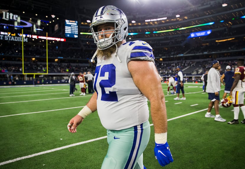 Dallas Cowboys center Travis Frederick (72) walks off they field after an NFL game between...