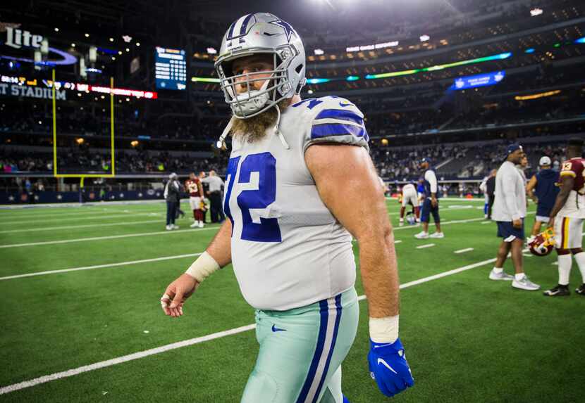 FILE - Cowboys center Travis Frederick (72) walks off the field after a game against the...
