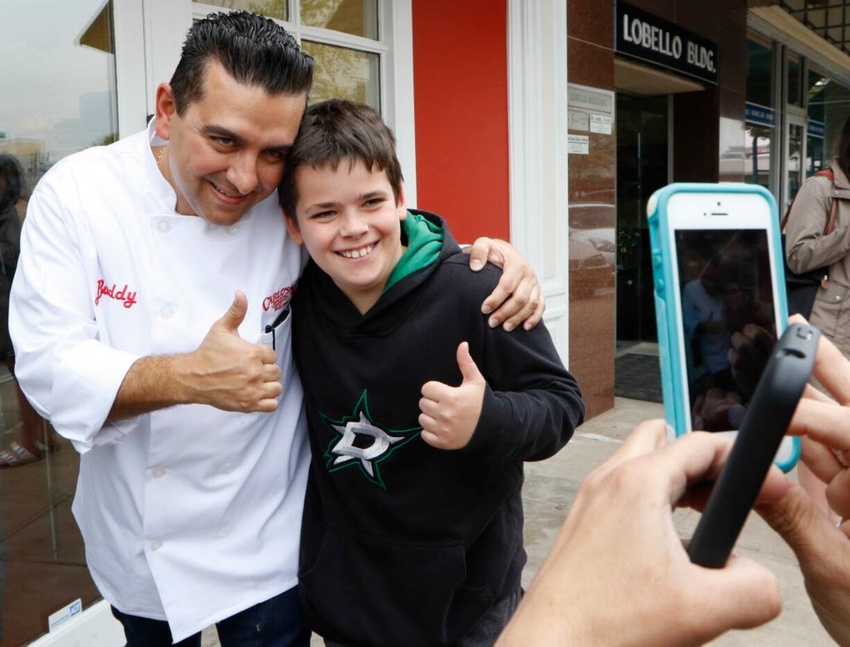 Buddy Valastro, left, took time out his busy day to pose with Harrison Gullatt, 10, at...