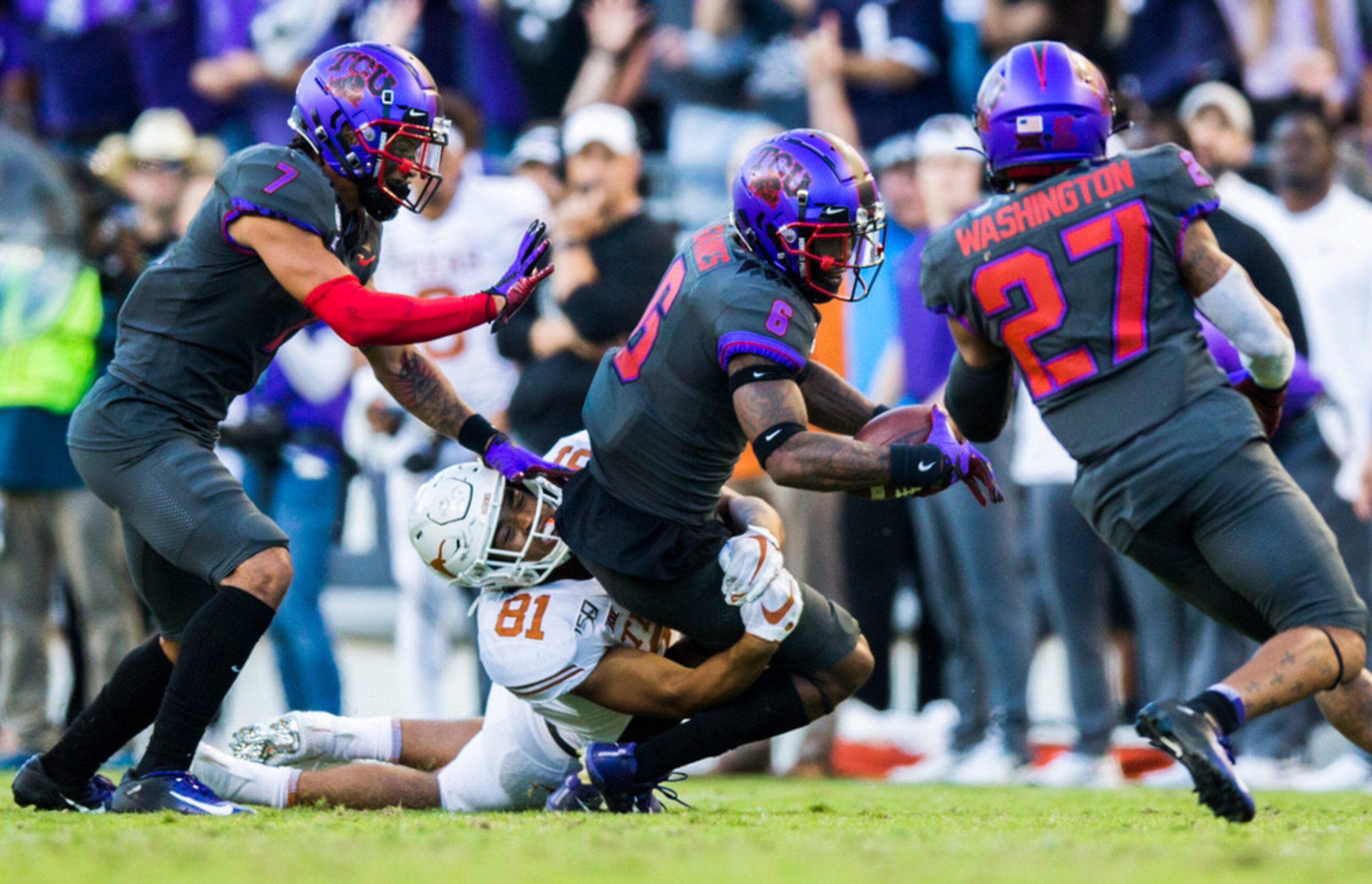 TCU Horned Frogs safety Innis Gaines (6) is tackled by Texas Longhorns tight end Reese...