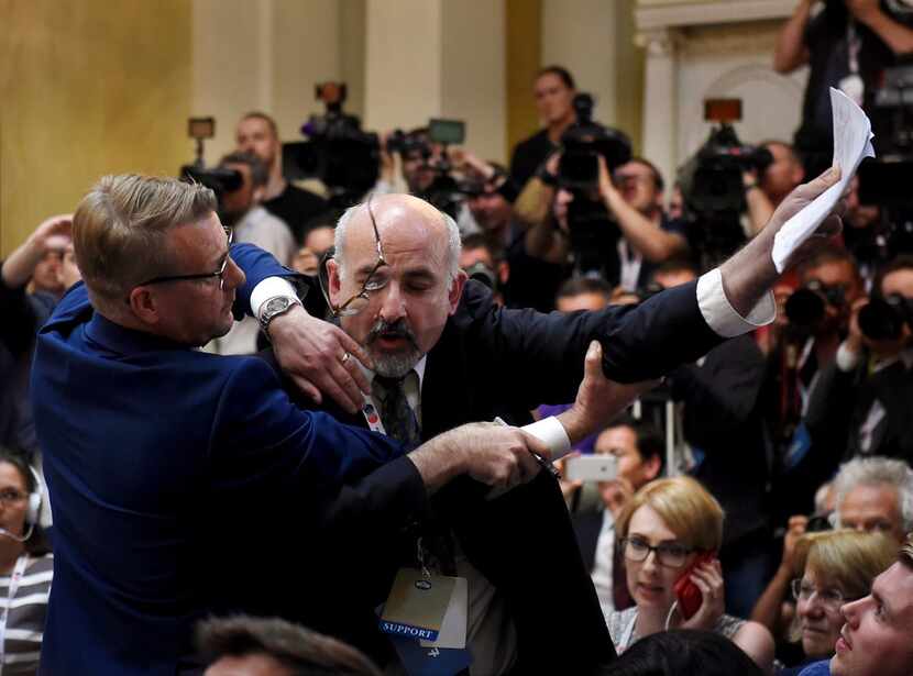 Security removes an apparent protester before a joint press conference between U.S....