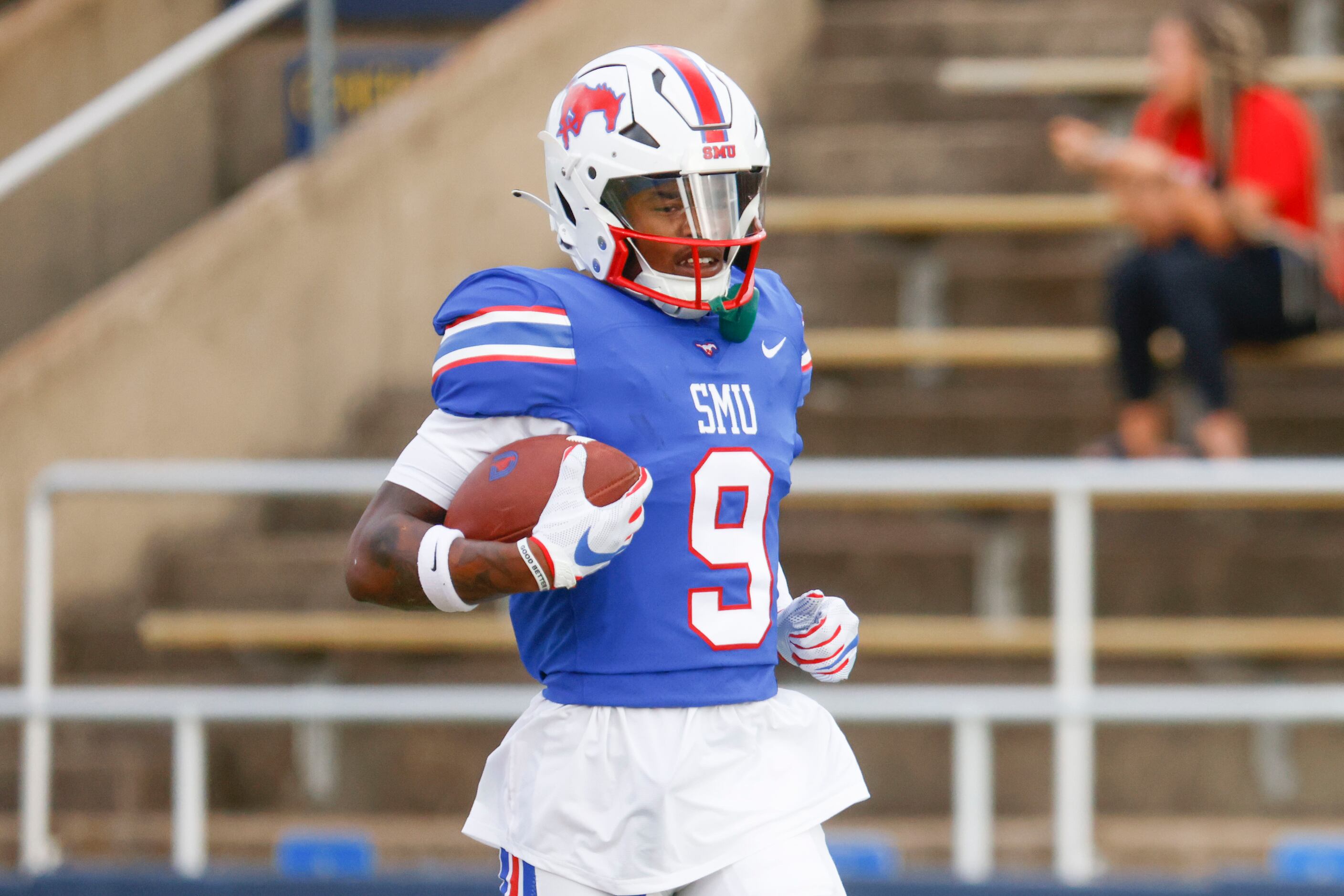 Southern Methodist defensive end Nelson Paul runs with the ball during an annual spring game...