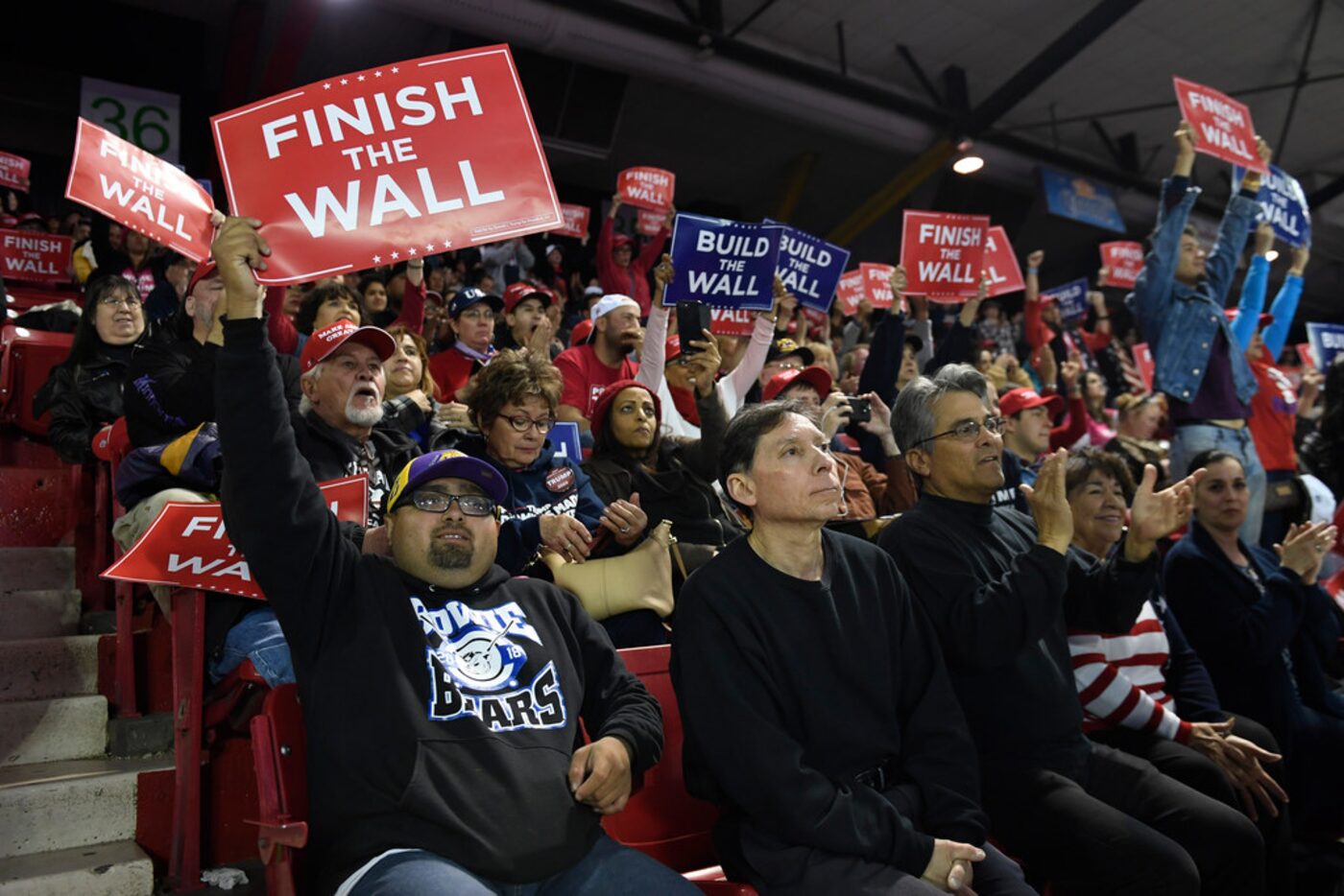 People respond as President Donald Trump speaks during a rally in El Paso, Texas, Monday,...