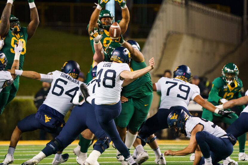 Baylor defensive tackle Bravvion Roy (99) blocks a field goal attempt by West Virginia place...
