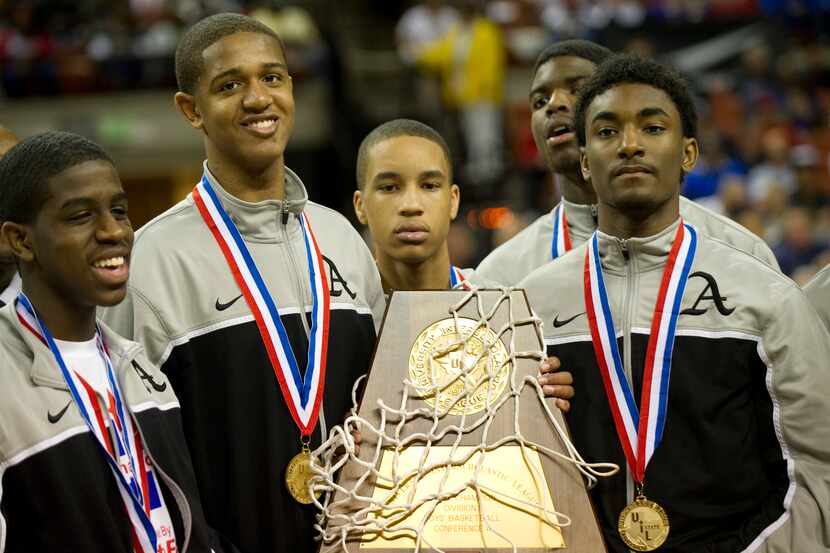 Dallas Triple A Academy celebrates with their trophy after defeating Mumford in the UIL 1A...
