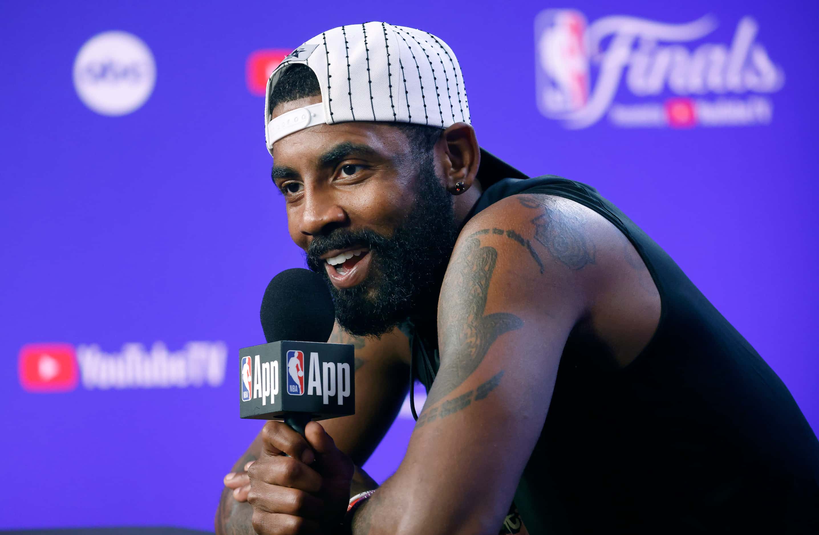 Dallas Mavericks player Kyrie Irving responds to a question from Utah Jazz rookie Keyonte...