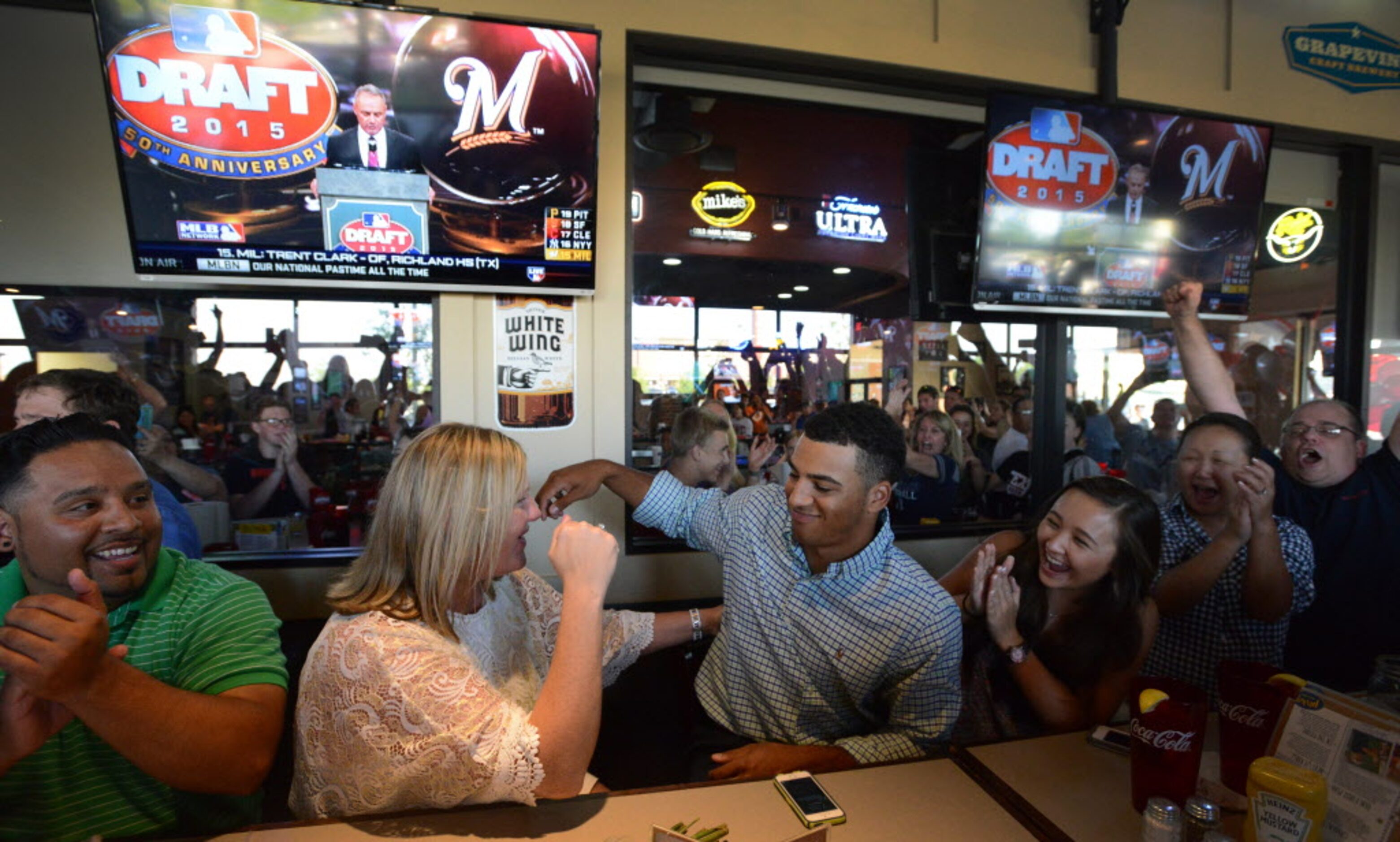 Family and friends celebrate as Trent Clark is drafted by the Milwaukee Brewers at a watch...