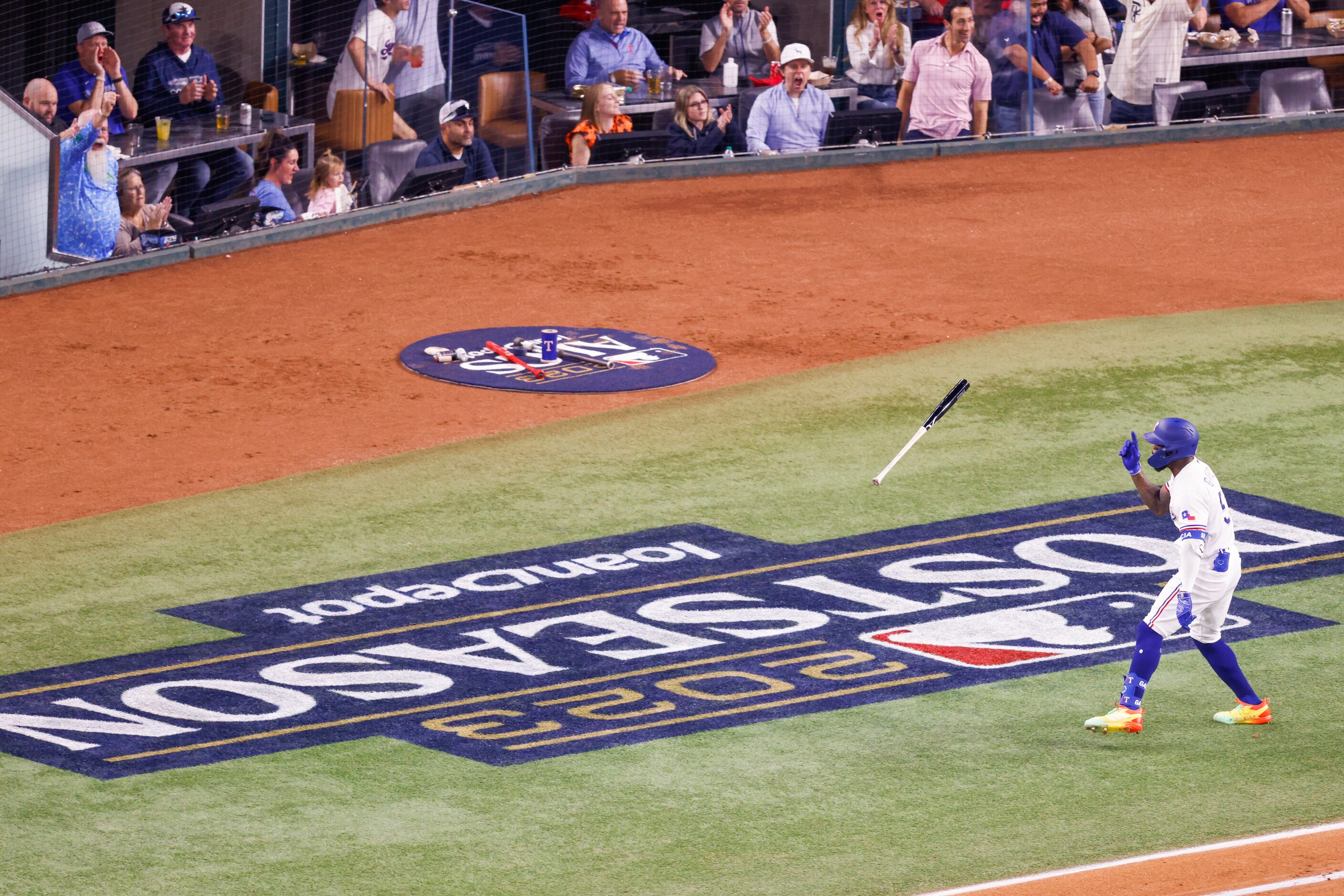 Texas Rangers right fielder Adolis Garcia (53) flips his bat in celebration after hitting a...