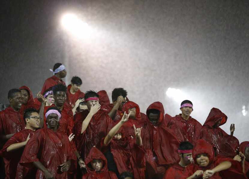 Cedar Hill band dances in the rain in between plays in a game against DeSoto during the...
