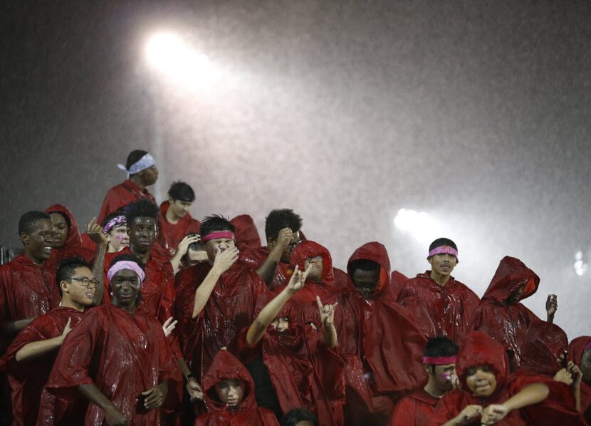 Cedar Hill band dances in the rain in between plays in a game against DeSoto during the...