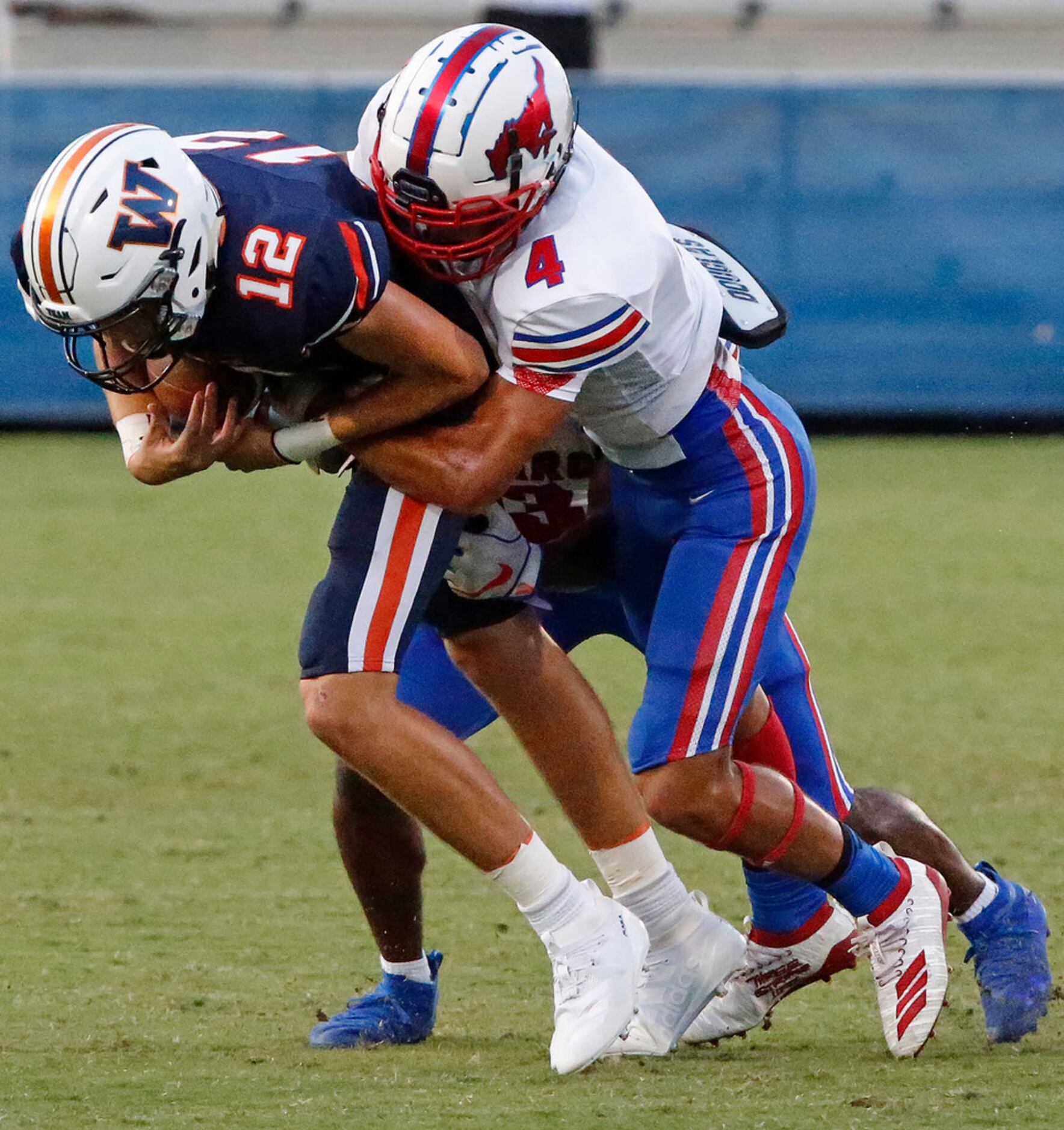 Frisco Wakeland High School quarterback Dylan Laible (12) is sacked by Richardson Pearce...