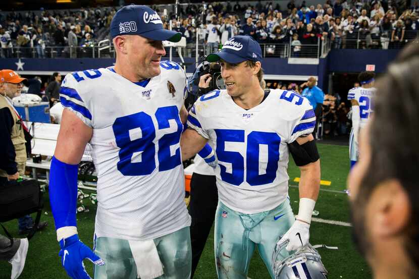 Dallas Cowboys tight end Jason Witten (82) and outside linebacker Sean Lee (50) hug after an...