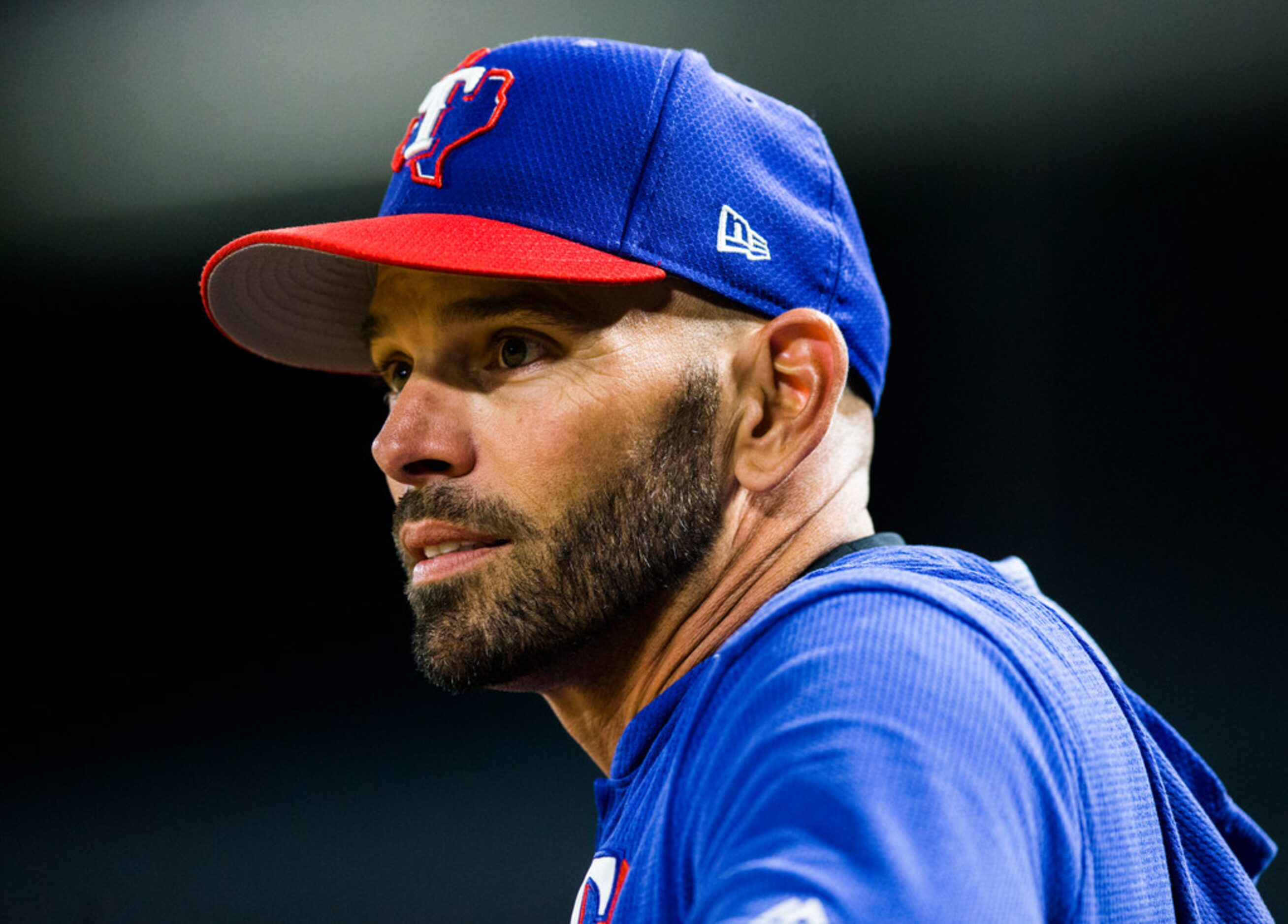 Texas Rangers manager Chris Woodward (8) watches from the dugout during the sixth inning of...