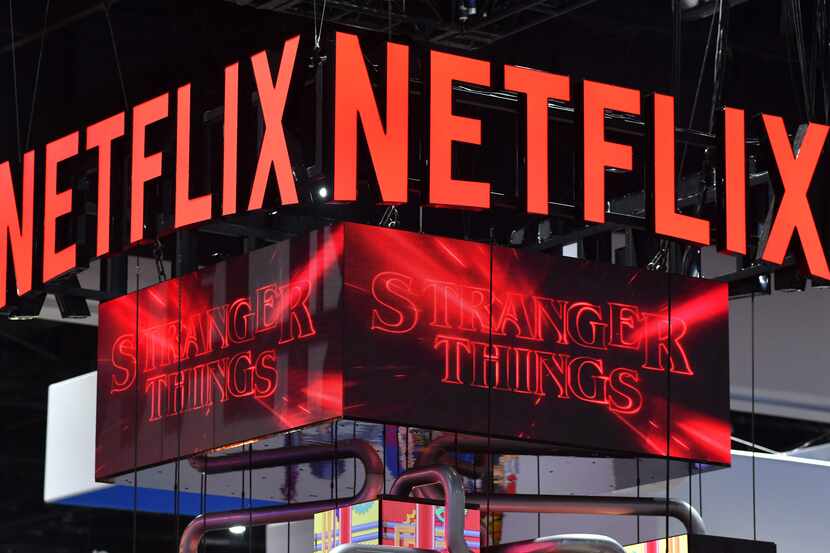 The Netflix booth advertises Stranger Things Season 4 on a screen during Comic-Con...