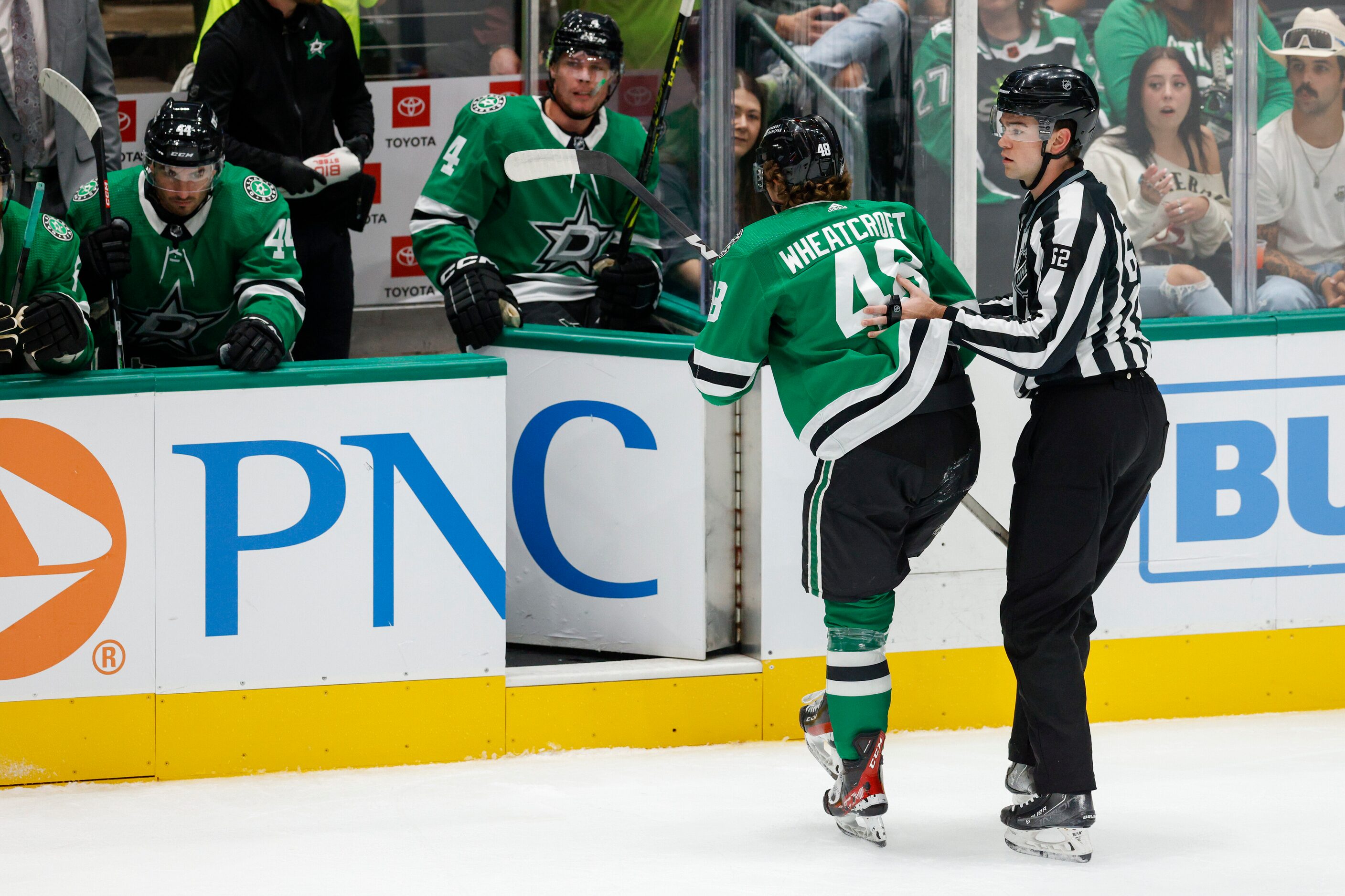 Dallas Stars center Chase Wheatcroft (48) is helped to the bench by a referee after blocking...