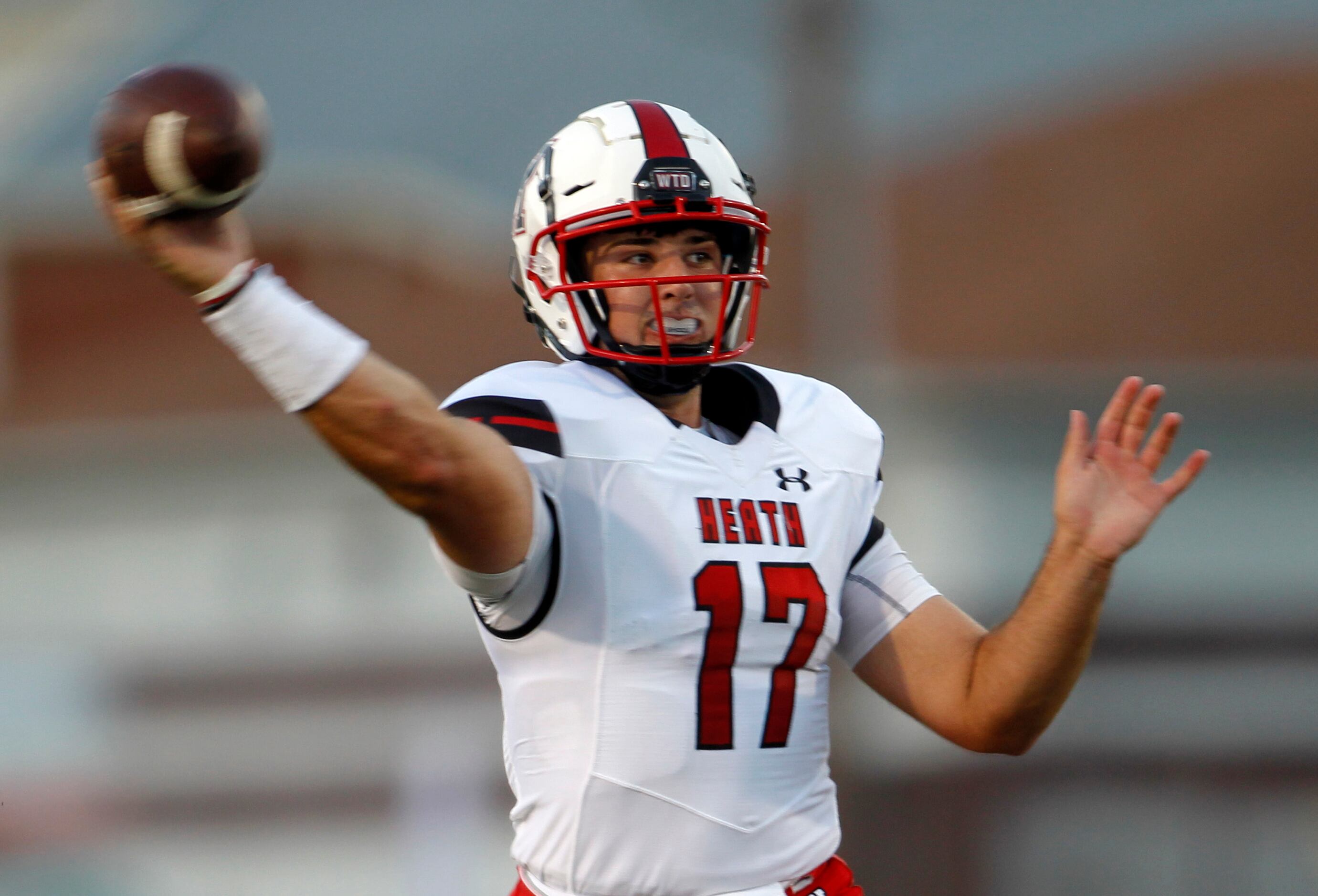 Rockwall Heath quarterback Josh Hoover (17) passes downfield during first half action...