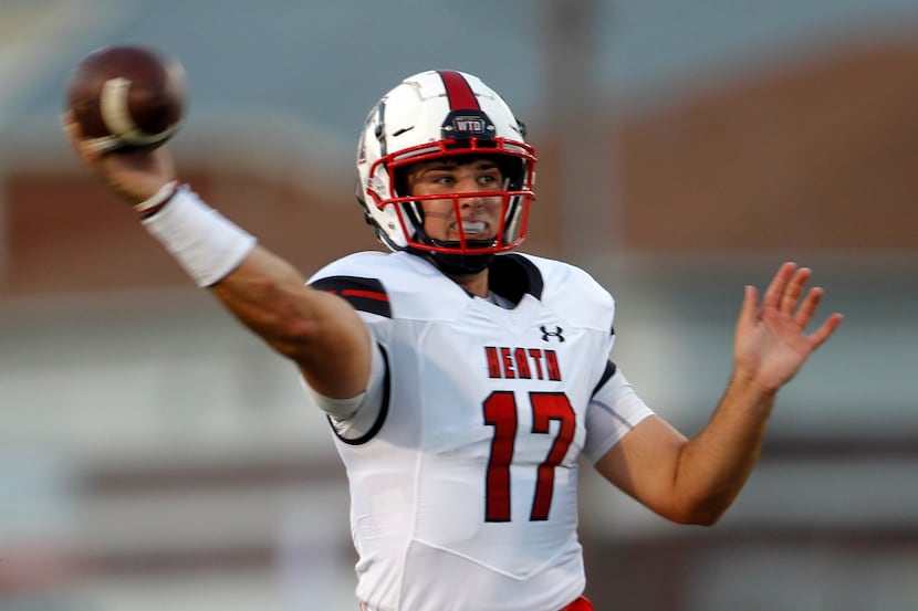 Rockwall Heath quarterback Josh Hoover (17) passes downfield during first half action...