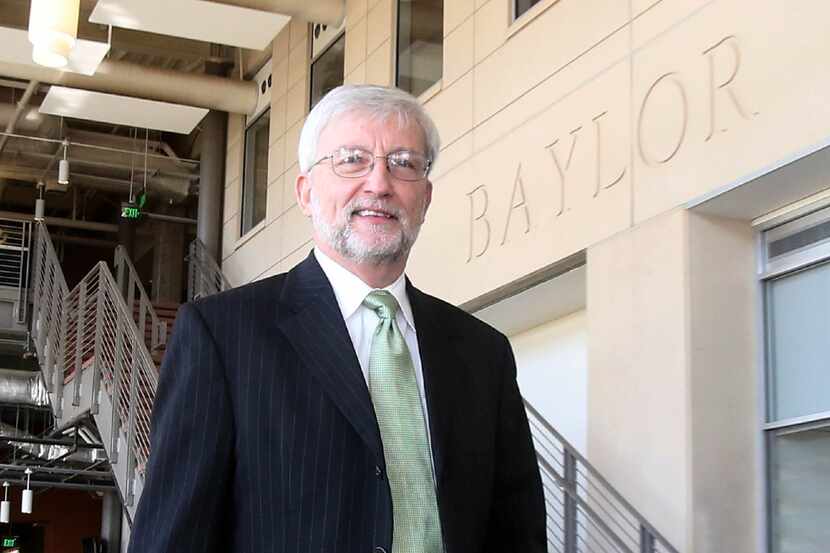 Dr. David E. Garland, interim president  Baylor University walks over to address the media,...