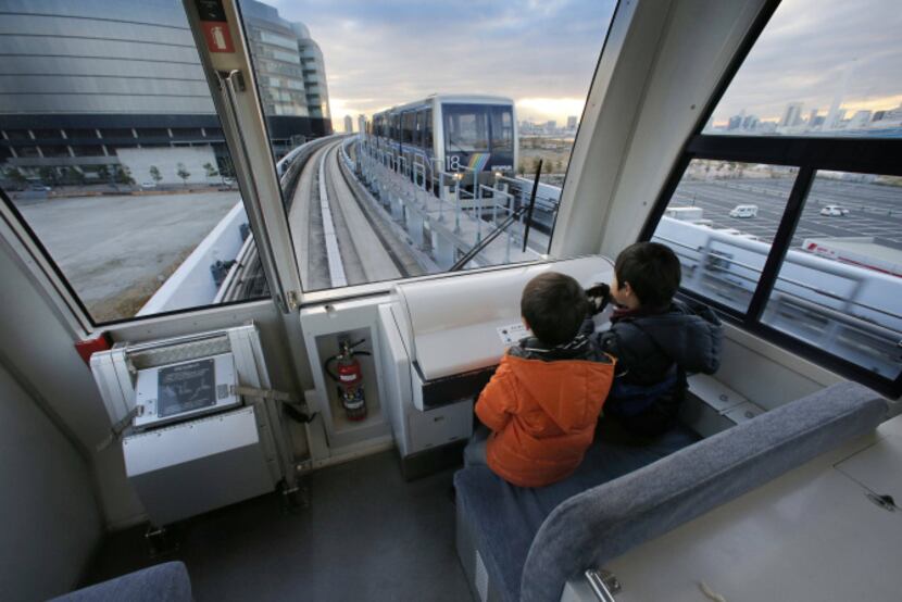 Children ride on Tokyo’s Yurikamome Line, which runs without a driver. A spokesman says the...