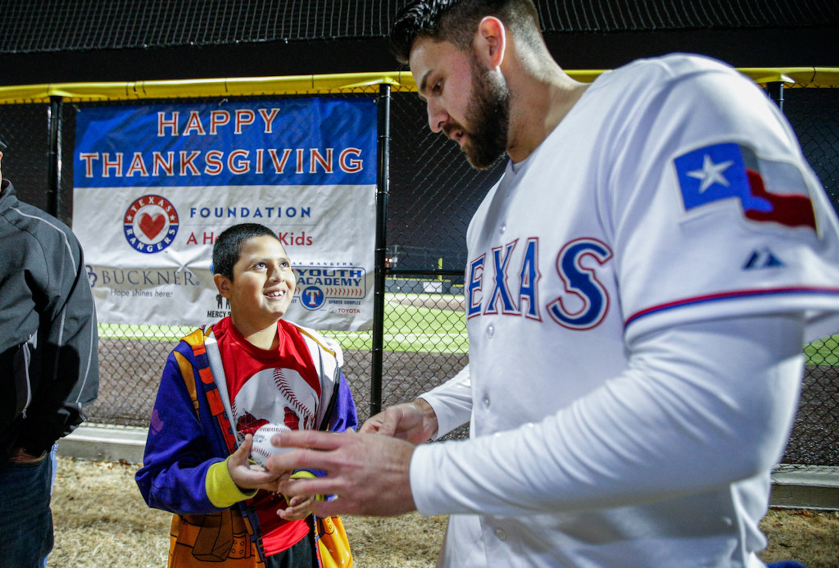 Texas RangersÃ Joey Gallo autographs a baseball for Antonio Estrada, 10, at the Texas...