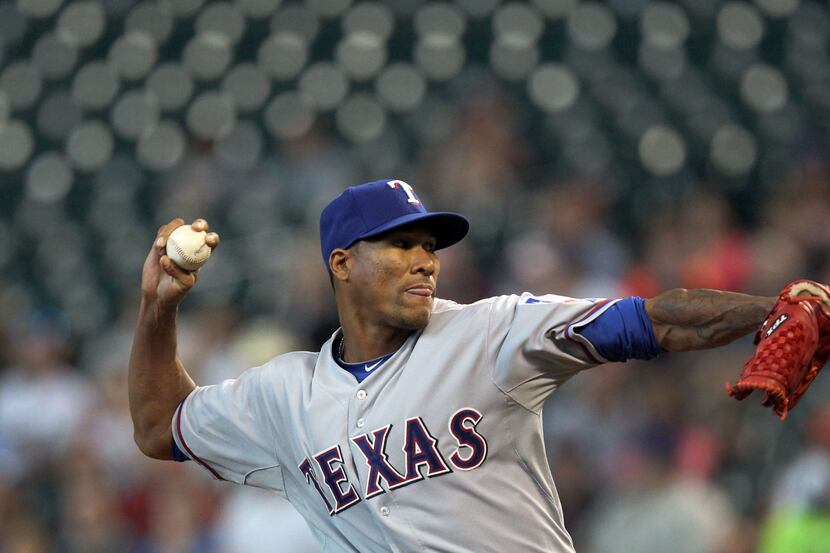 Texas starting pitcher Alexi Ogando throws a first inning pitch during the Texas Rangers vs....