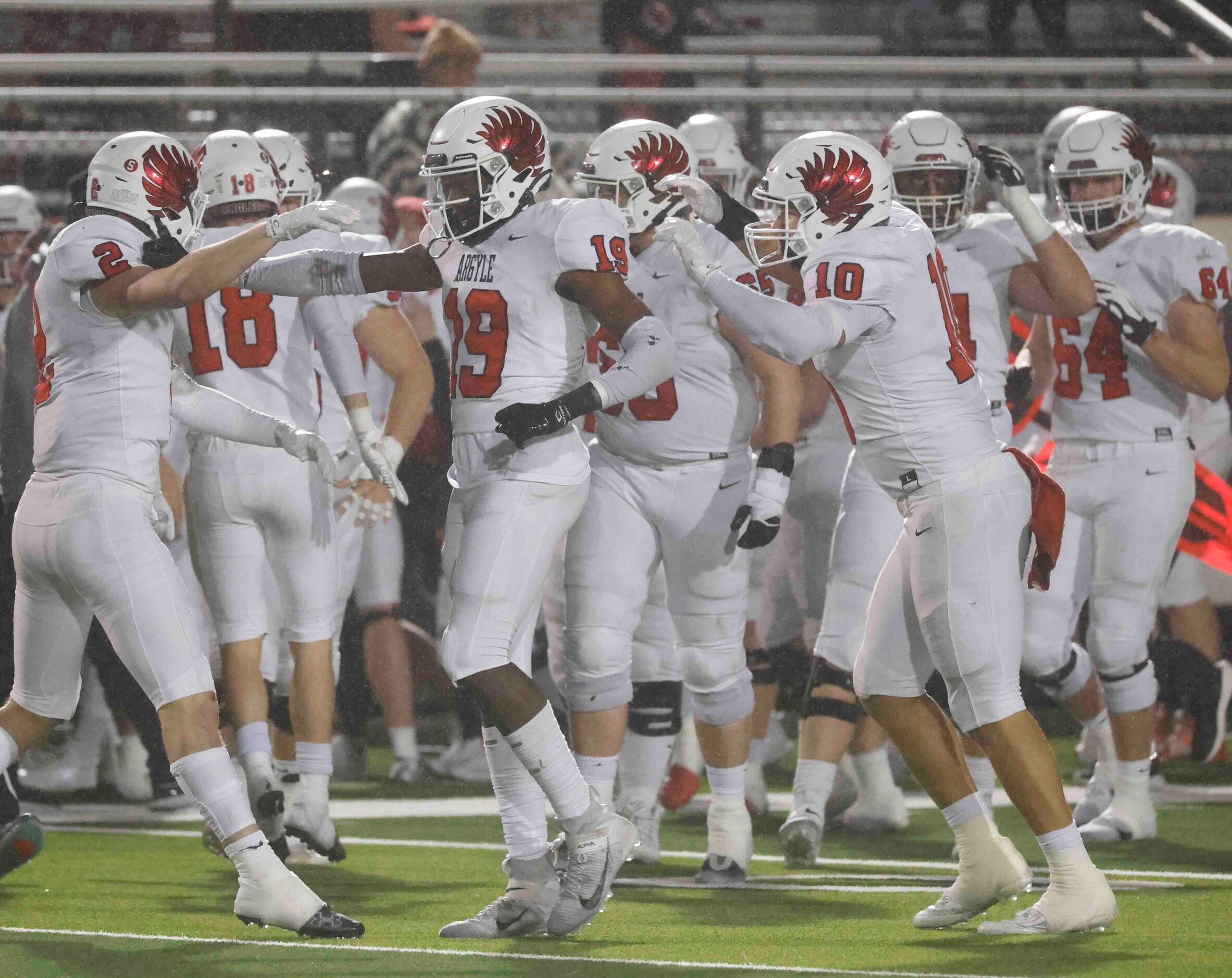 Argyle High players celebrate an interception against Grapevine High during the second half...