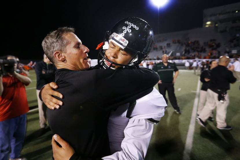 Mansfield Lake Ridge injured quarterback Jett Duffey receives a congratulatory hug from head...