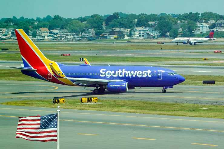 Southwest Airlines and Delta Airlines aircraft taxi at Boston Logan Airport on Tuesday, June...