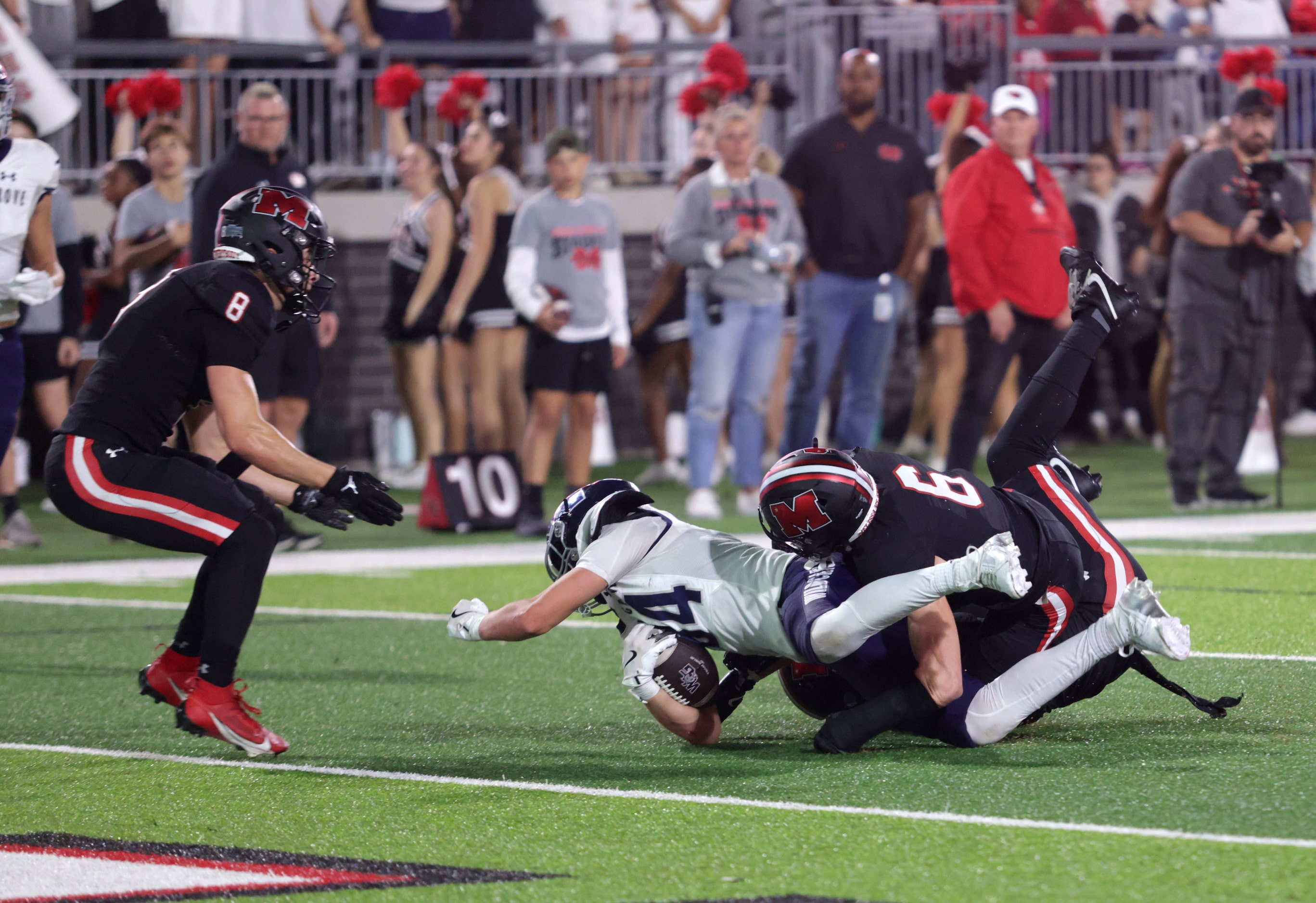 Walnut Grove player #84 Hayden Cooley is pulled down by Melissa player #6 Jared Potucek...