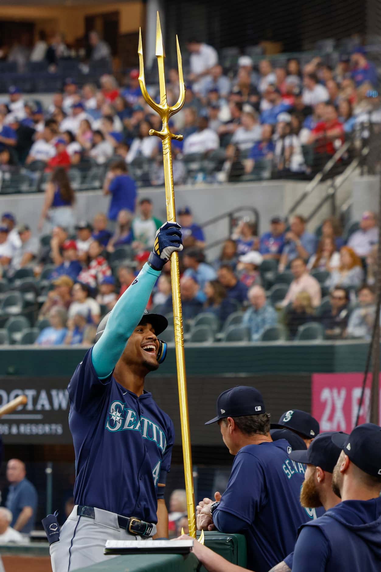 Seattle Mariners center fielder Julio Rodriguez (44) hoists a trident as he celebrates his...