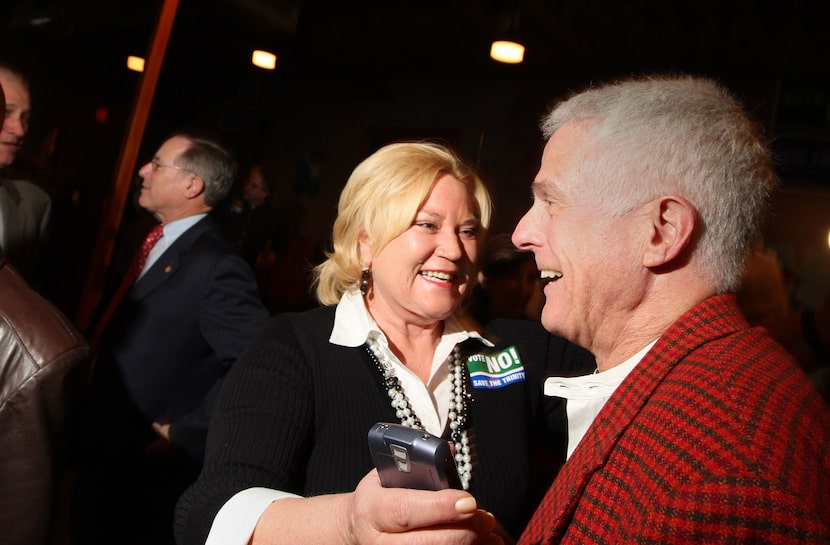 Carol Reed, left, hugs Craig Holcomb at a watch party at Gilley's in 2007. 