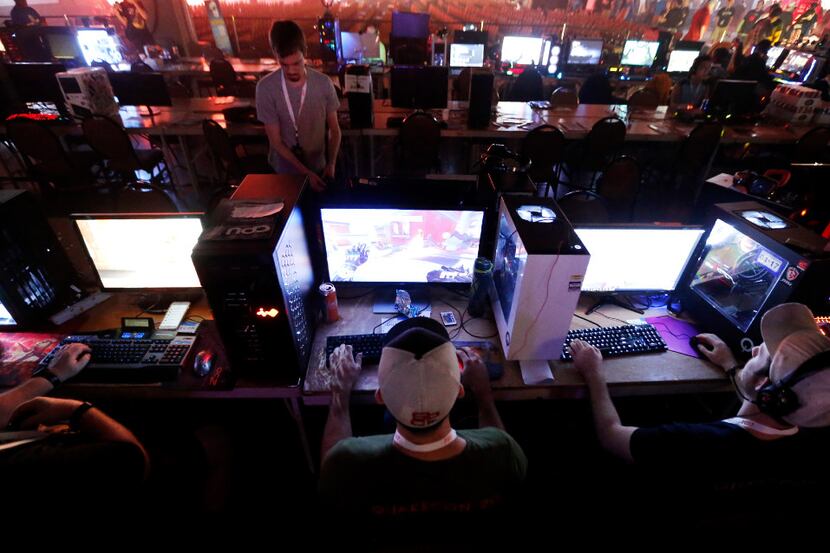 Joseph Morjan, center, and Joseph Fadely of Forney play a match of "Overwatch" during...
