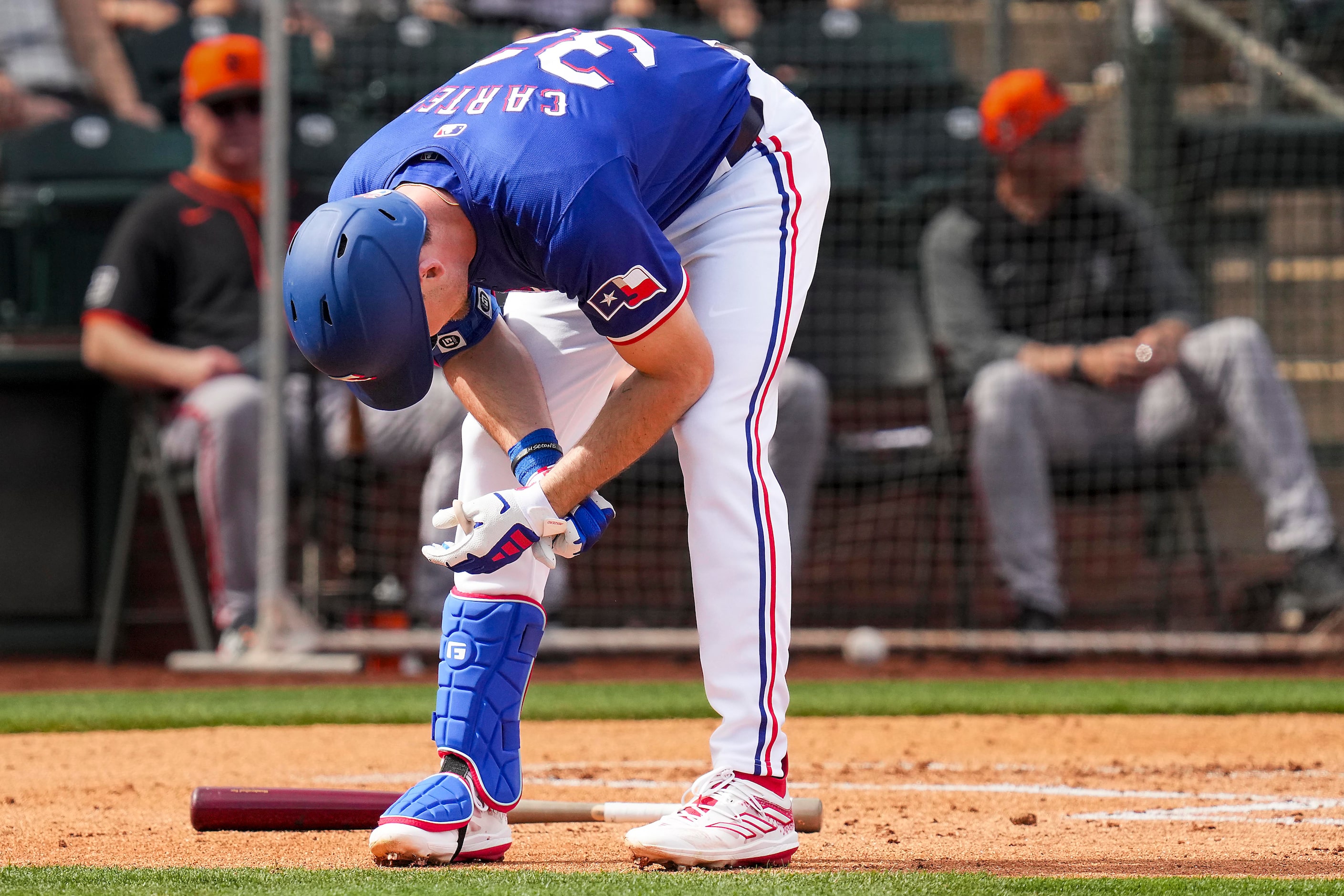 Texas Rangers outfielder Evan Carter reacts after being hit by a pitch during the first...