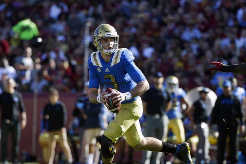 FILE - In this Nov. 28, 2015, file photo, UCLA quarterback Josh Rosen looks for a receiver...