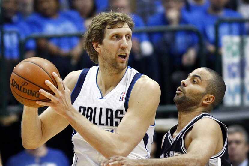 San Antonio Spurs guard Tony Parker (9) crowds Dallas Mavericks forward Dirk Nowitzki (41)...